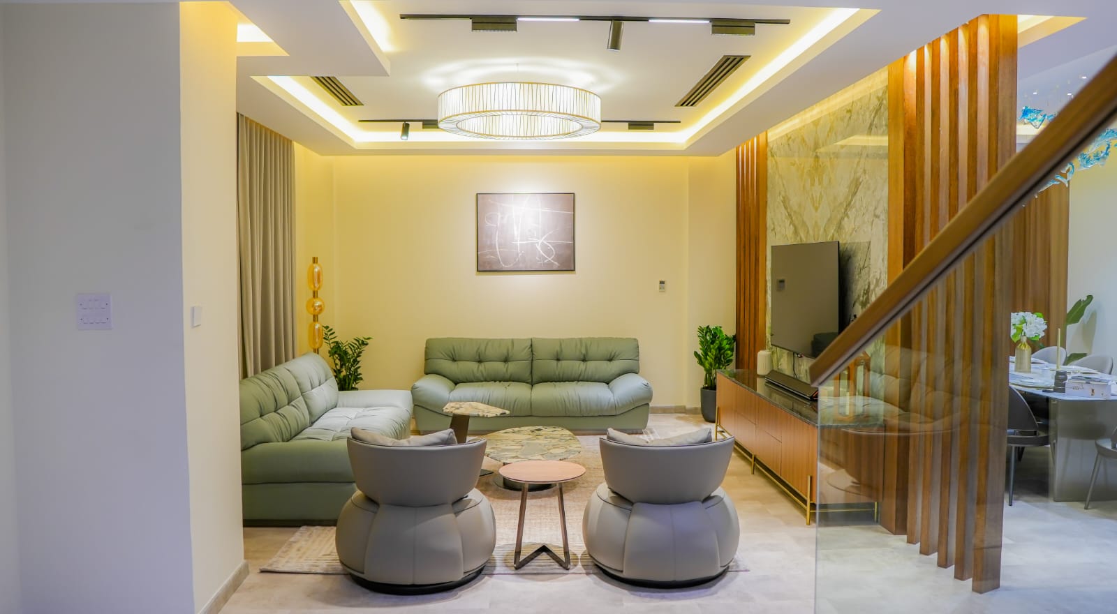 Living room styled by Pentazone Interiors with sage sofa and sculptural bouclé armchairs